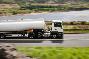 Fototapeta na wymiar Big fuel gas tanker truck on blurred road