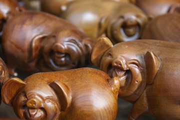 Pig toys or souvenirs made of wood at a tourist stall