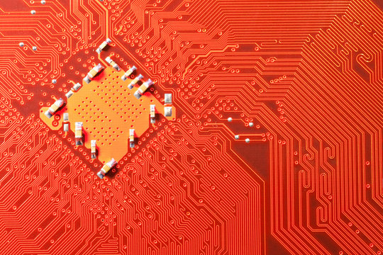 Closeup of computer circuit board in orange