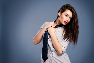 Fototapeta premium Beautiful sexy woman in a man's shirt and tie