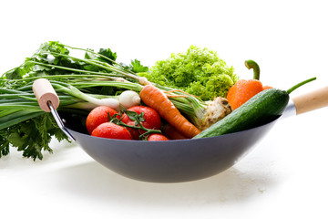 Fresh vegetables in chinesse wok on white background