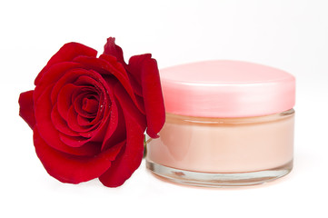Face cream container and red rose