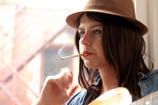 Girl in Brown Suede Hat Smoking