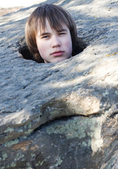 young man in an aperture in  stone on  nature