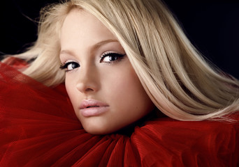 Attractive blond beauty in a red theatrical jabot. Close-up Port - obrazy, fototapety, plakaty