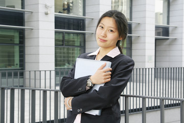 A beautiful Asian businesswoman holding the  documents