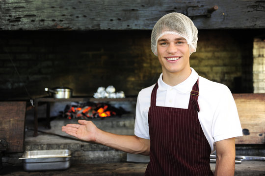 Man Working At A Restaurant Showing Wood-fired Oven