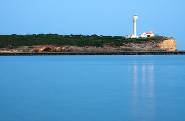 Portuguese lighthouse at the end of the day in Algarve Portugal