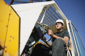 Fototapeta na wymiar Construction Worker Using Equipment