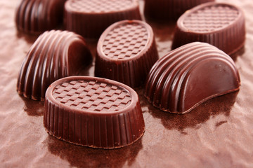 Assorted chocolate candies on brown
