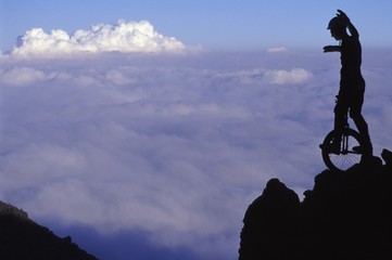 Man On Cliff Riding Unicycle © Image Source