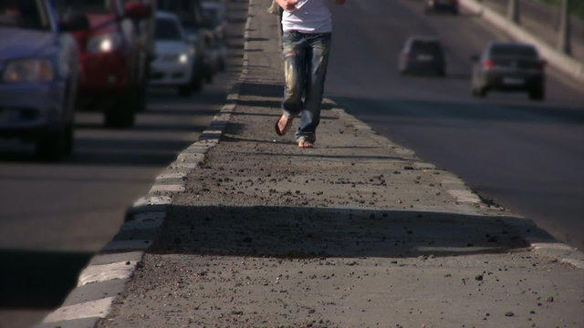 feet of girl running to camera on highway middle