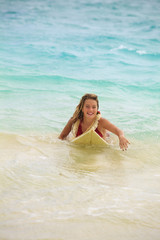 Fototapeta premium teenage girl in the ocean with her surfboard at kailua beach