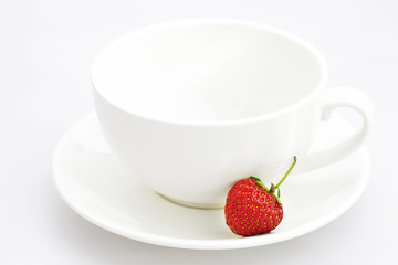cup saucer and strawberries isolated on white