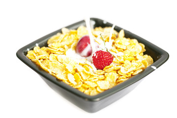 bowl of cornflakes milk  cherry  and strawberry  isolated on whi