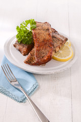 homemade hot smoked salmon fillet, on white wood with fork, pars