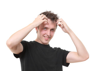 The young man holds hands at a head and smiles