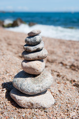Fototapeta na wymiar Beach with stacked stones