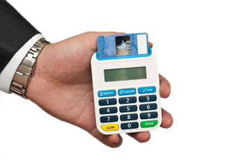business mans holding a card reader with a credit card inside