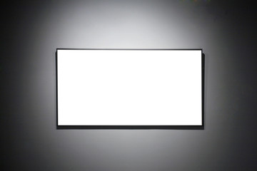 empty frames in a room against a white wall .