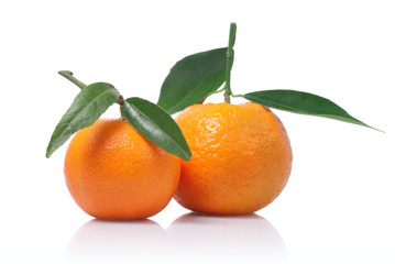 Tangerines with green leaves isolated on white