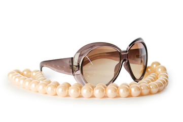 Pearl necklace and sunglasses isolated on the white background