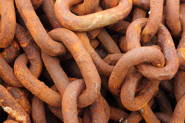 Old rusty ship anchor chain links close up.