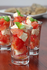 Fototapeta na wymiar Caprese appetizers with tomatoes, mozzarella and basil