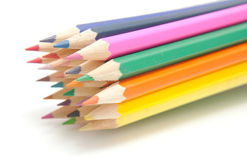 colorful pencils over white background