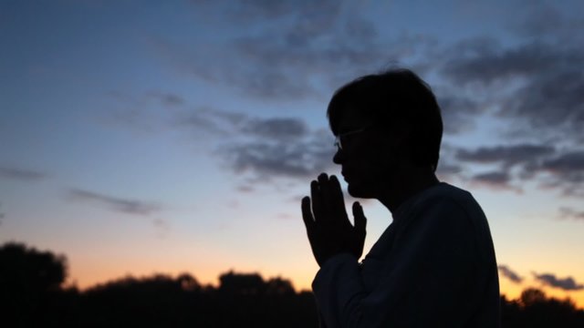 person pray against sky