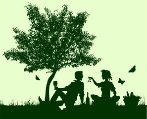 couple picnicunder a young tree