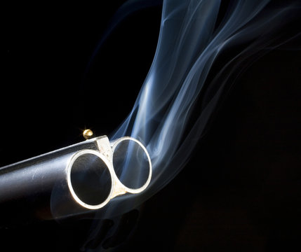 both barrels on a double barreled shotgun still smoking after shooting
