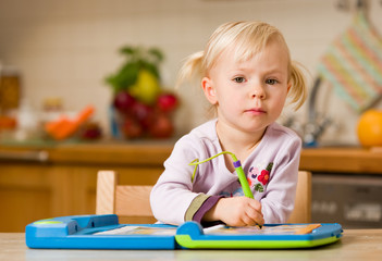 girl playing with toy computer - obrazy, fototapety, plakaty