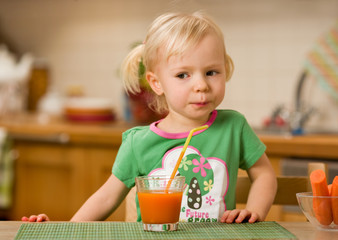little girl with carrot juice
