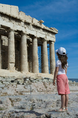 Child in front of Ancient Parthenon in Acropolis Athens Greece.