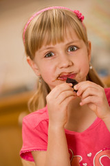 girl eating chocolate - obrazy, fototapety, plakaty