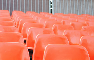 Orange plastic bleachers, shallow depth of field