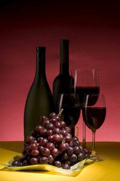 Red grape and wine bottle still life