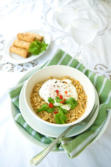 Bowl of spicy oriental noodles with poached egg