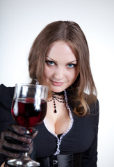 Sensual blue-eyed woman with glass of wine