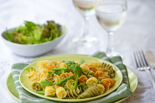 Colorful pasta with asparagus served on outdoor dining