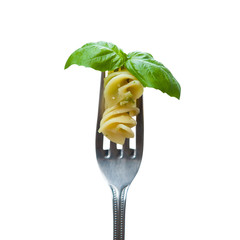 Isolated pasta and basil leaf on fork