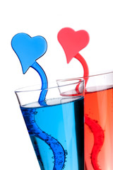 Two champagne alcohol cocktails with heart decoration