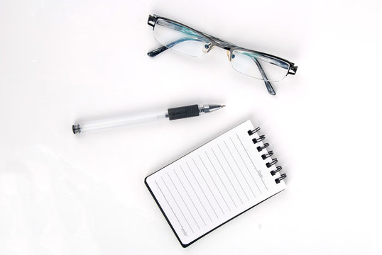 glasses,pen with notebook