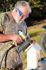 Senior Man Building a Bird House
