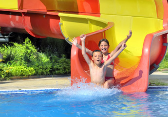 children sliding down a water slide