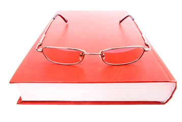 Glasses on a closed book