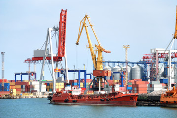 The trading seaport with cranes, cargoes and ship