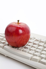 Computer Keyboard and red apple