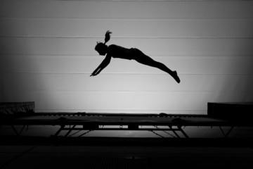 silhouette of girl on trampoline